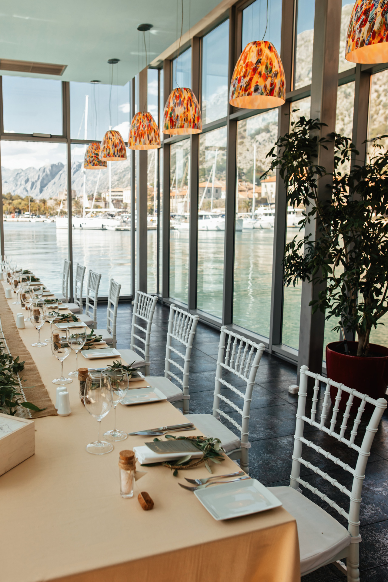 decorated wedding reception venue with view sea through windows